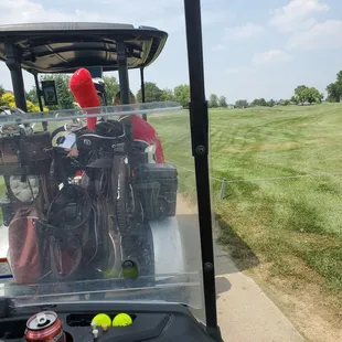 a man driving a golf cart