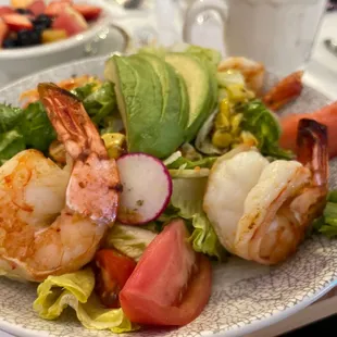 a salad with shrimp and vegetables