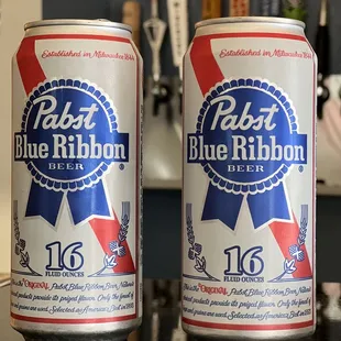 two cans of pale blue ribbon beer