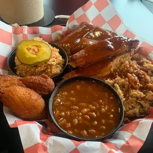 Three meat plate: ribs, brisket, pulled pork with bbq beans, red slaw, hush puppies.