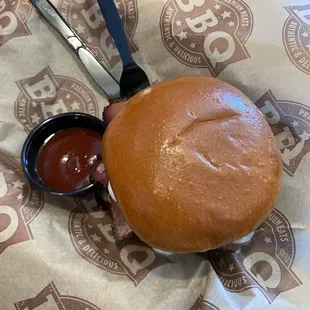 Cheese brisket sandwich with sauce on the side