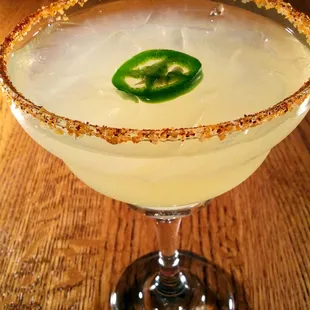 a margarita with a jalapeno on the rim