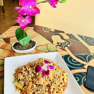 a plate of noodles and a flower