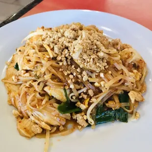 a plate of noodles with meat and vegetables