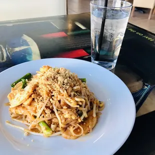 a plate of noodles and a glass of water