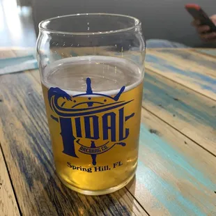a glass of beer on a wooden table