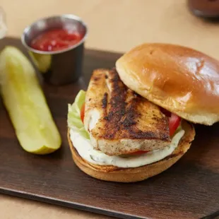 a grilled chicken sandwich with a side of fries