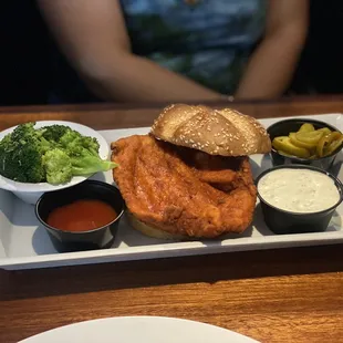 Fried Buffalo chicken sandwich with broccoli