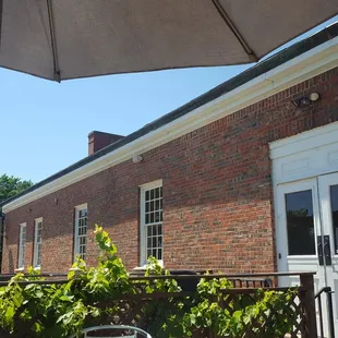 a patio with a table and chairs under an umbrella