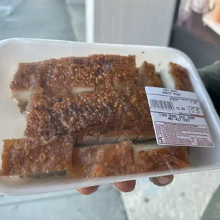 a person holding a tray of food