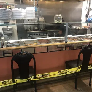 a restaurant kitchen with yellow caution tape