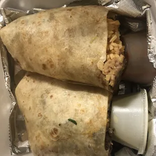 two burritos wrapped in foil