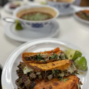 Cheese tacos with asada, bowl of birria