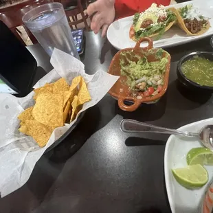 Chips, salsa, and a little guacamole and pico.   (Note the quac bowl may be for Cinco de mayo)