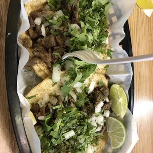 Carne asada tacos with cilantro and onion