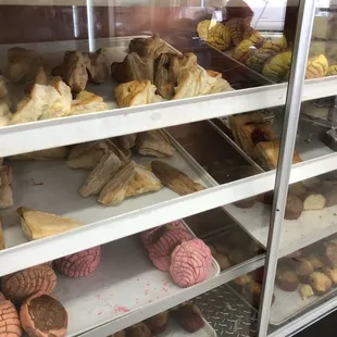 a variety of pastries in a display case