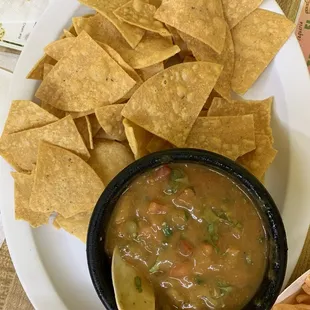 Chips and salsa.  Salsa is red and green salsa mixed with fresh pico. Very good and very spicy.