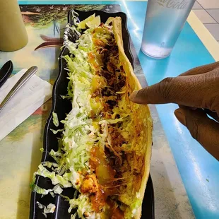 a hand reaching for a taco