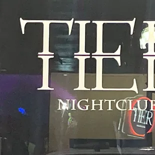 the reflection of the sign in the window