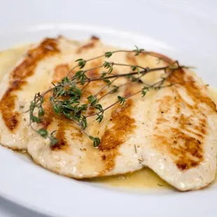 Grilled chicken breast in a lemon-butter sauce