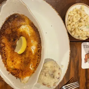 Baked fish with mashed potatoes and macaroni salad.