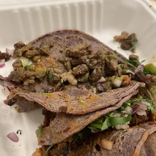 Carne asada, pollo and Al pastor tacos. Organic blue corn tortillas.