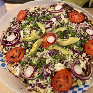 Tlayuda is like a giant Mexican pizza. It is a must try here.