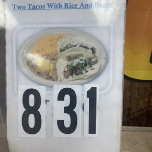 a plate of tacos with rice and beans
