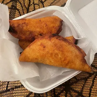 two pastries in a styrofoam container