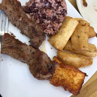Torta de Carne Asada (steak torta) , rice and beans, fried cheese, and yucca fries