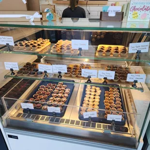 a display case with a variety of pastries