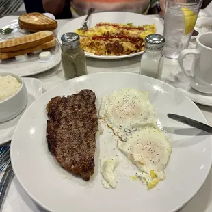 Sirloin steak and two over easy eggs, with a side of grits (SO VOLUMINOUS AND YUMMY)