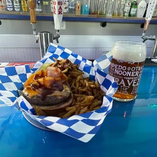 BBQ bacon cheddar cheeseburger with a beer