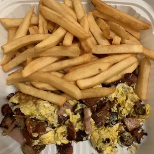 a breakfast sandwich and french fries in a styrofoam container