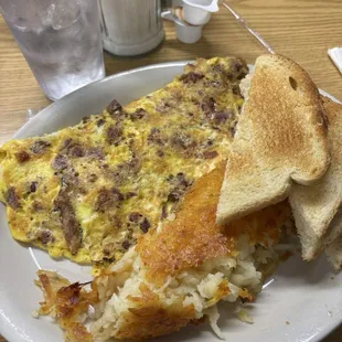Bacon and cheddar omelette, toast, and hash browns.