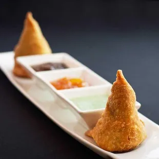 Vegetable Samosa Crispy flour pastry with potato and peas filling.