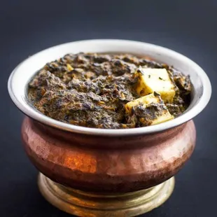 Saag Paneer...Homemade cottage cheese in spinach sauce and enriched with herbs. Includes Basmati rice.