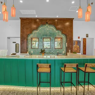 a teal bar with stools