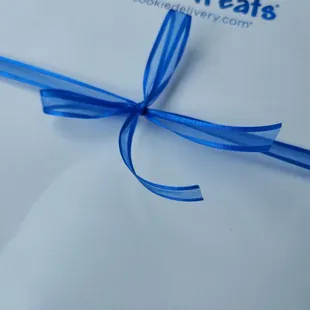 a blue ribbon tied to a package