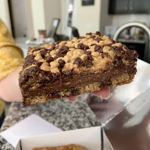 a hand holding a chocolate chip cookie