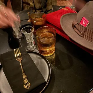 a man setting a table with a hat and glasses