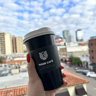 a hand holding a cup of coffee