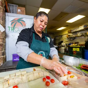 a woman preparing food in a kitchen