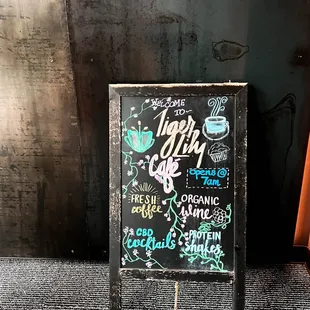 a chalk board with a sign that says tiger lily cafe