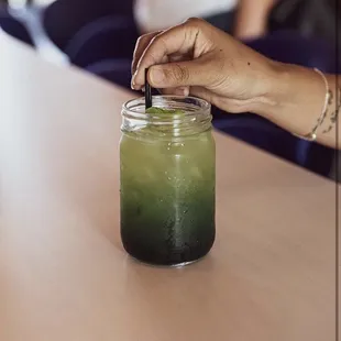 &quot;Calypso&quot; Cocktail Drink. NO ALCOHOL: Contains 30mg of CBD oil, Kombucha, Spirulina, Cucumber, Agave, &amp; Mint leaves. Photo from Tiger Lily