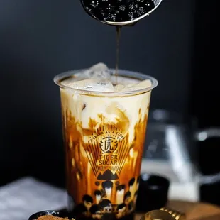 iced coffee being poured into a cup