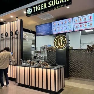 a woman standing in front of a counter