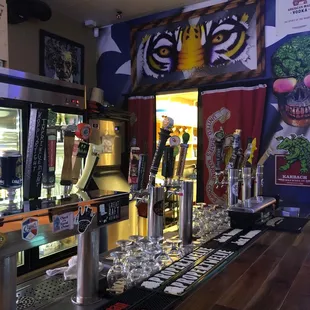 a bar with beer taps and beer glasses