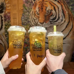 two people toasting their drinks