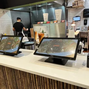 a restaurant counter with a man in the background